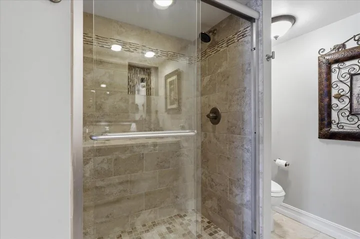 WALK IN SHOWER WITH SEAMLESS GLASS DOORS IN THE GUEST BATH
