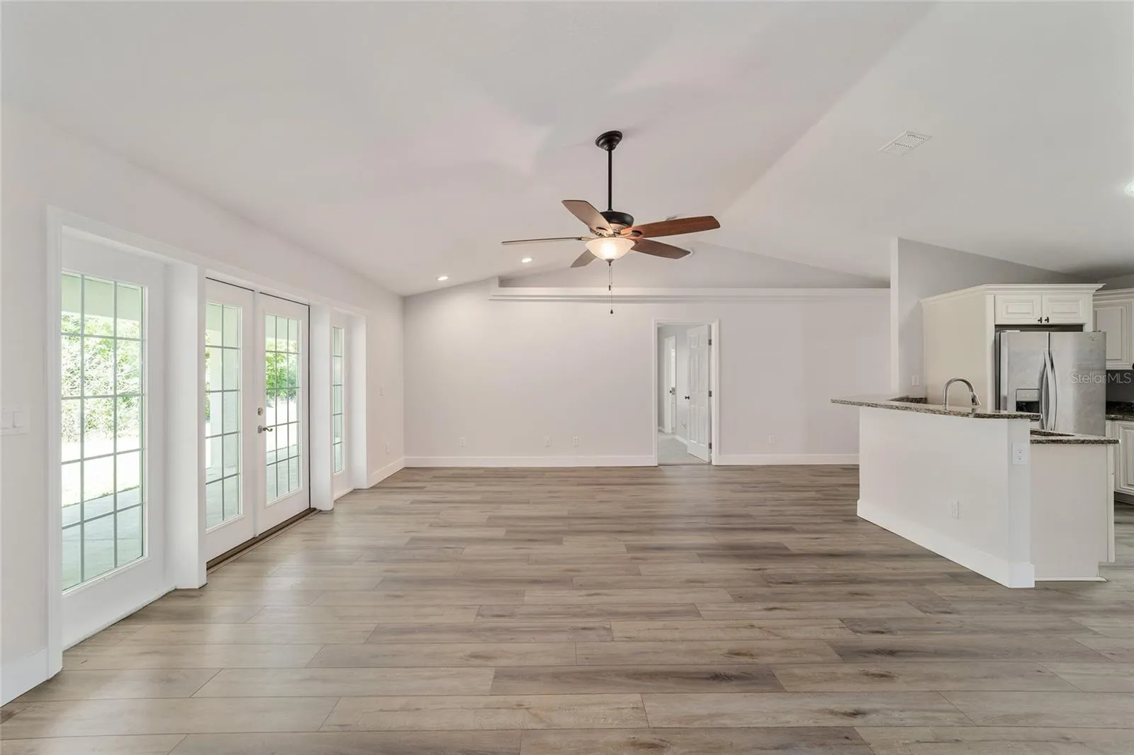 Includes view of the kitchen and the backyard.