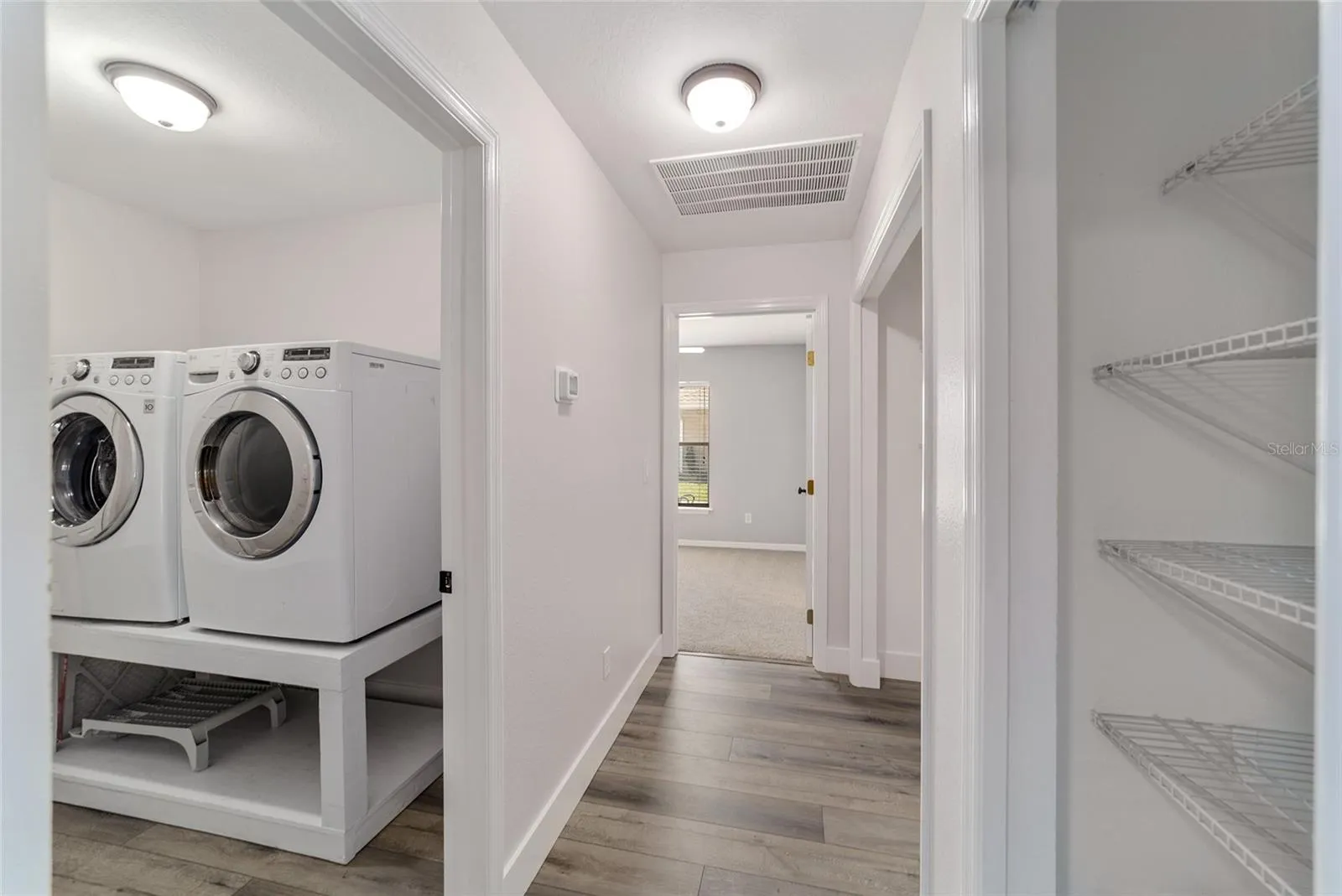 Private Laundry Room entrance from front hallway next to the kitchen leading towards the 1st Bedroom