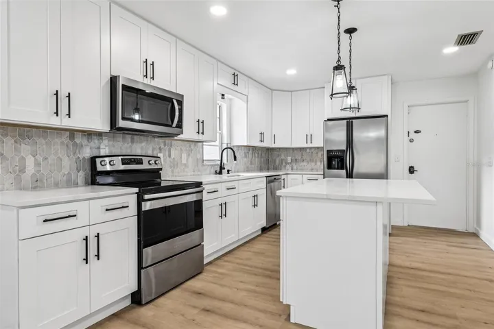 Brand new modern kitchen is open to the living and dining spaces.