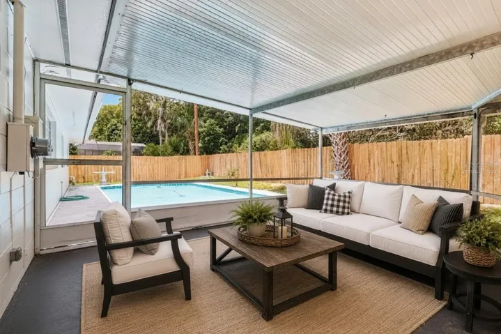 Relax poolside in the screened lanai. Virtually Staged.