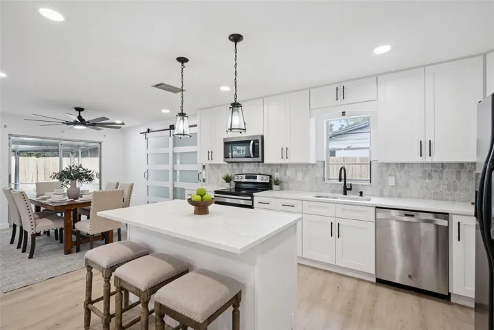 Brand new modern kitchen is open to the living and dining spaces.