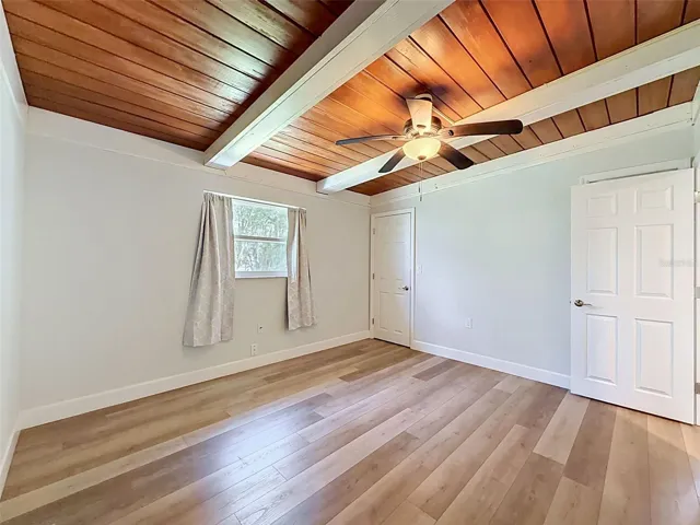 • Bright secondary bedroom with clean coastal finishes.