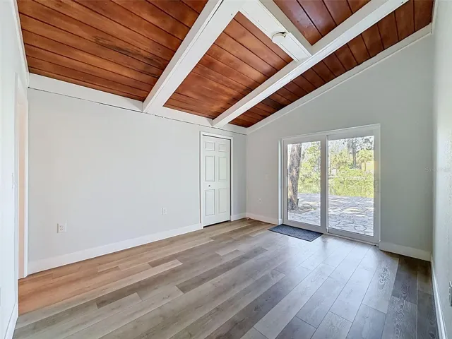 Bright primary bedroom offering indoor-outdoor flow and a relaxing coastal atmosphere.