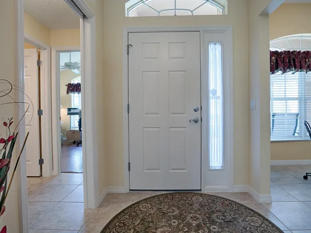 FOYER WITH HALLWAY AHEAD, KITCHEN ON YOUR LEFT, AND GUEST WING ON THE RIGHT ... LOVELY LARGE TILE FLOORING IN THE KITCHEN, HALLS, BATHROOMS, AND LAUNDRY.
