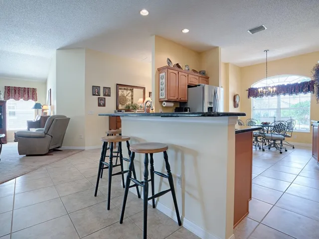 LARGE TILE FLOORING IN THE KITCHEN AND HALLWAYS.