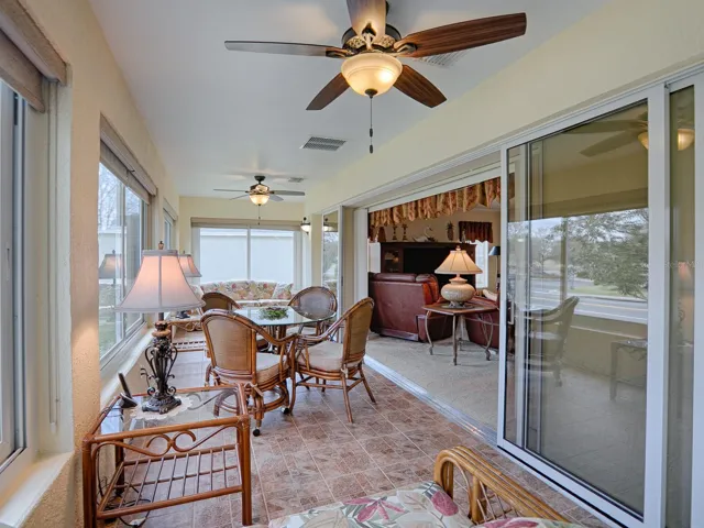 STACKBACK SLIDING GLASS DOORS OPEN TO THE FLORIDA ROOM.