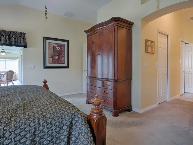 SLIDING GLASS DOORS TO THE LEFT LEAD TO THE FLORIDA ROOM. ARCHWAY ENTRY LEADS TO YOUR DUAL CLOSETS AND EN SUITE PRIMARY BATHROOM!