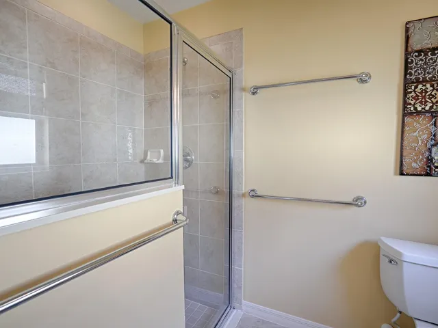 SEPARATE TOILET / SHOWER ROOM WITH TILE FLOORING AND ANOTHER WINDOW FOR NATURAL LIGHT.