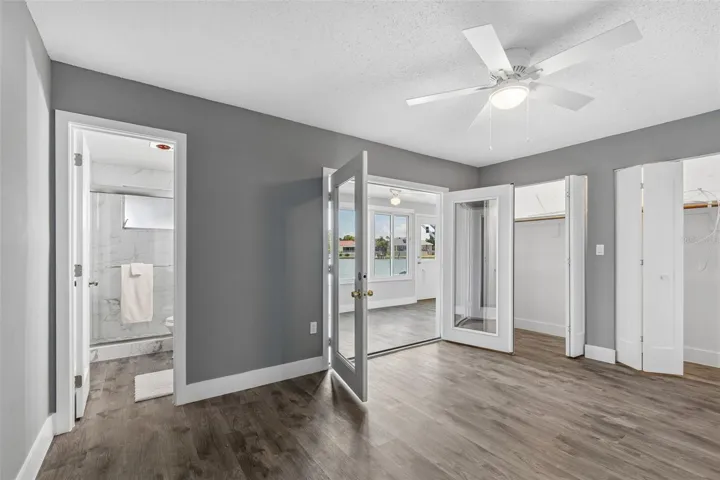 Primary Bedroom with French Doors out to the Florida Room