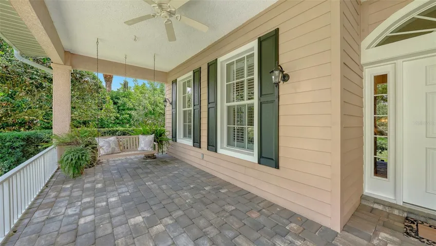 Front porch with a bench swing.
