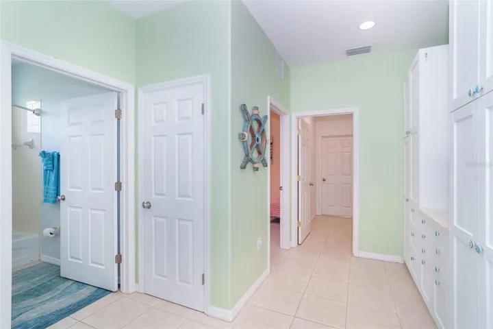 Pantry Area to the right. Guest Bathroom to the Left. Indoor Laundry stright ahead to Garage