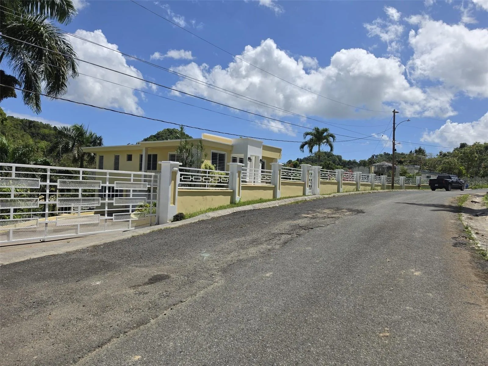 Hacienda del Dorado, Dorado, Puerto Rico property offering 4 bedrooms, 2.5 bathrooms, 2,500 sq. ft. of living space on a 3,947 sq. meter lot. Gated community with 24-hour security and excellent access to main roads in Dorado. Spacious layout with double carport for 4 vehicles and lower-level areas with plumbing and electrical ready for future conversion. Large lot provides privacy and expansion potential in a prime Dorado residential location.