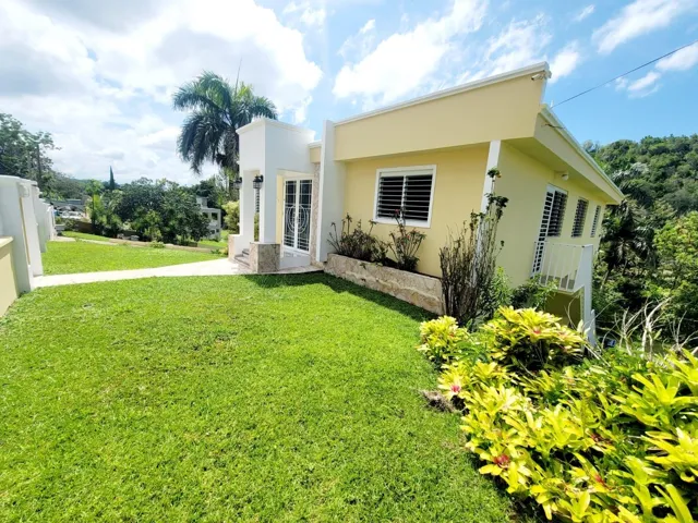 Hacienda del Dorado, Dorado, Puerto Rico property offering 4 bedrooms, 2.5 bathrooms, 2,500 sq. ft. of living space on a 3,947 sq. meter lot. Gated community with 24-hour security and excellent access to main roads in Dorado. Spacious layout with double carport for 4 vehicles and lower-level areas with plumbing and electrical ready for future conversion. Large lot provides privacy and expansion potential in a prime Dorado residential location.