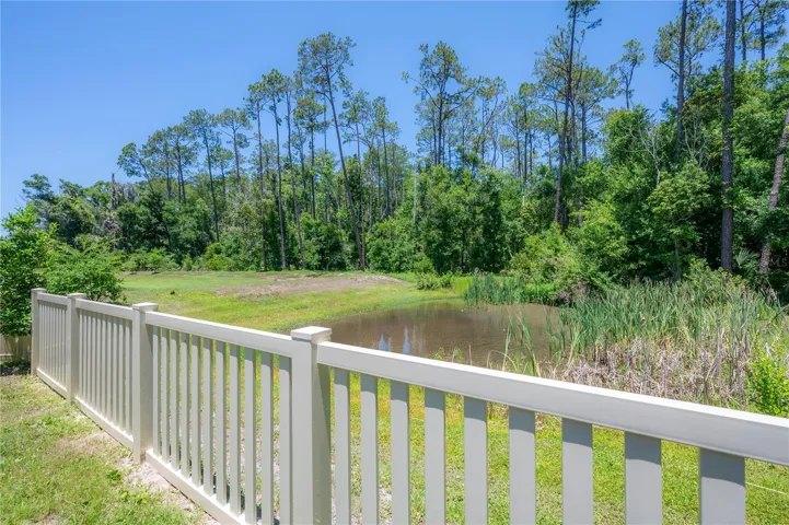 Private fenced backyard with peaceful pond and conservation views