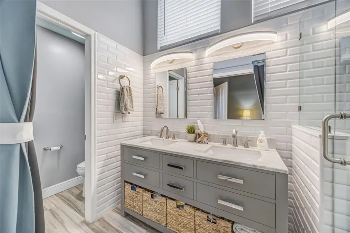 Updated en-suite bathroom with dual sink vanity.