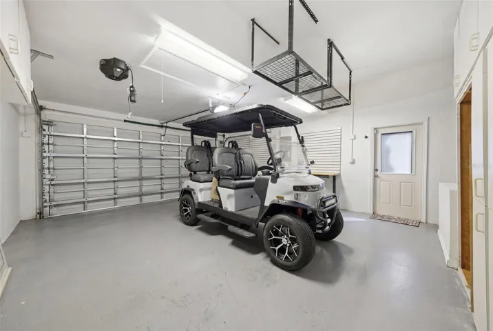 GARAGE HAS CABINETRY AND OVERHEAD STORAGE. EAST LAKE WOODLANDS IS A GOLF CART FRIENDLY COMMUNITY. (golf cart not included)