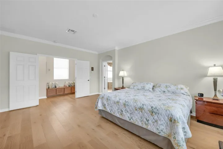 Primary bedroom with engineered hardwood flooring
