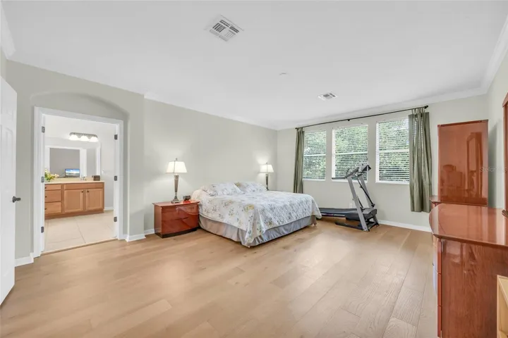 Primary bedroom with engineered hardwood flooring