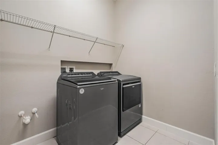 Walk-in laundry room with ventilated shelving
