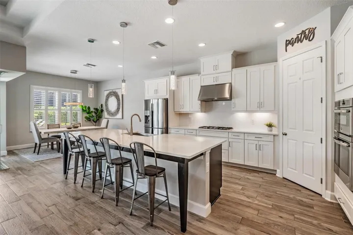 Crisp, white kitchen with breakfast bar seating