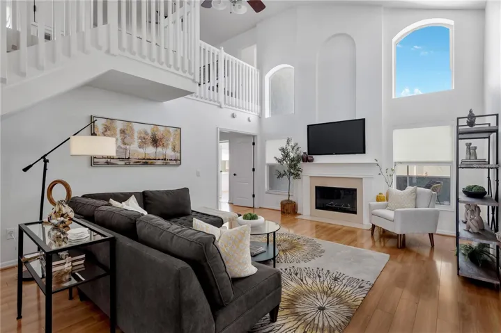 Grand livingroom with high ceilings & fireplace.
