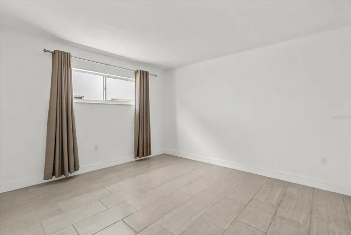 Primary bedroom with tile floors