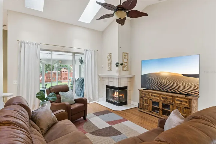 The ultimate gathering space. This expansive Great Room features soaring vaulted ceilings with knockdown texture and a classic wood-burning fireplace.