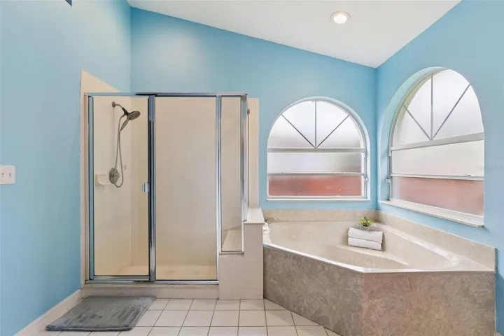 Unwind in the deep garden tub or utilize the separate shower in this beautifully laid out primary bathroom retreat.
