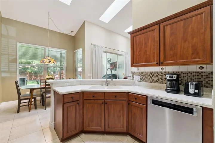 Looking across the convenient breakfast bar into the main living areas—perfect for keeping the chef connected with family and guests while entertaining.