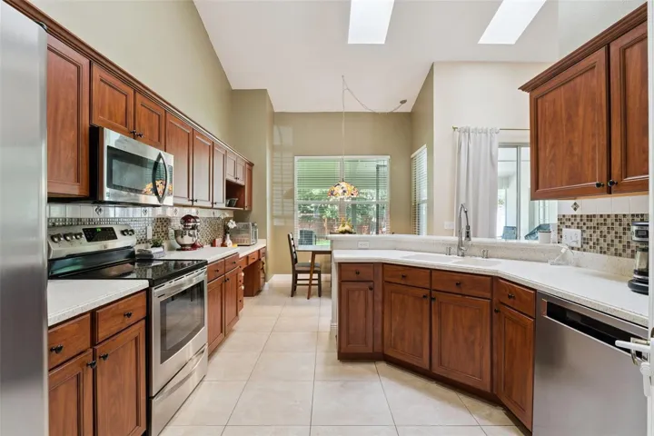 This well-appointed kitchen features ample cabinet storage, updated appliances, and a layout that overlooks the sunny breakfast nook.