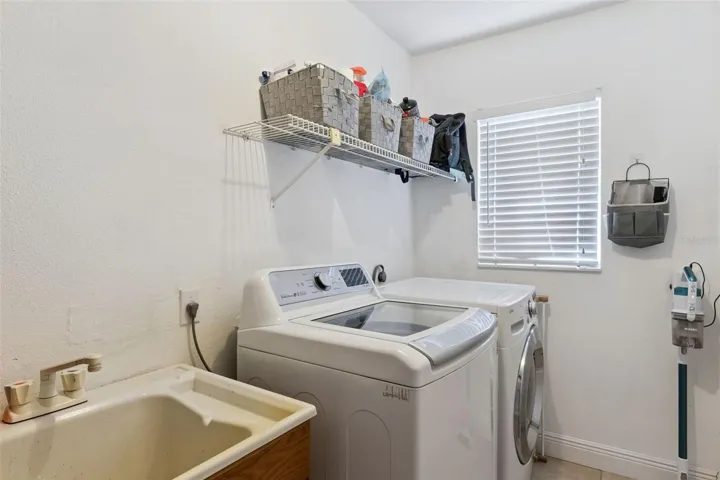 This dedicated indoor utility room keeps your laundry tucked away from the main living spaces while offering extra convenience and overhead storage potential.