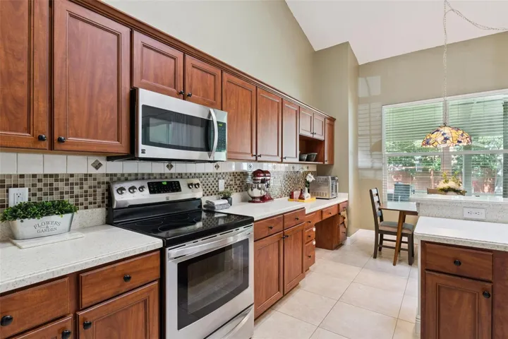 An open-concept kitchen designed for the home chef! Equipped with stainless steel appliances, durable Corian countertops, and an extended counter for extra prep space.