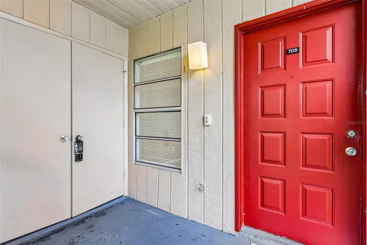 Screened front entry with convenient laundry closet.