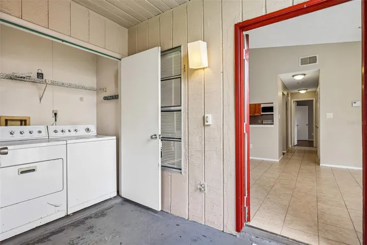 Screened front entry with convenient laundry closet.