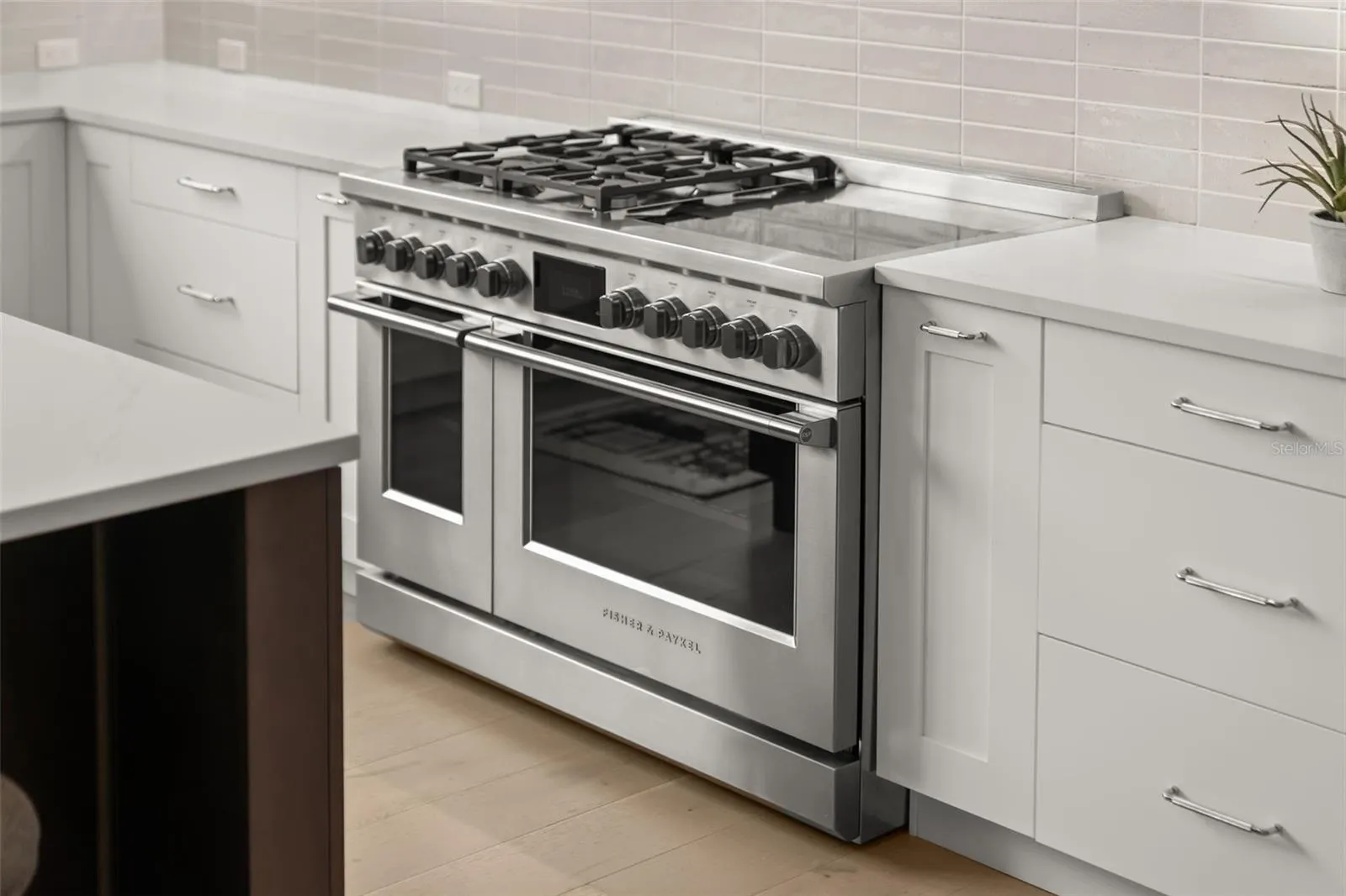 Imagine cooking on this Fisher &amp; Paykel range featuring 4 gas burners and 4 induction burners with an oversized stainless-steel hood!