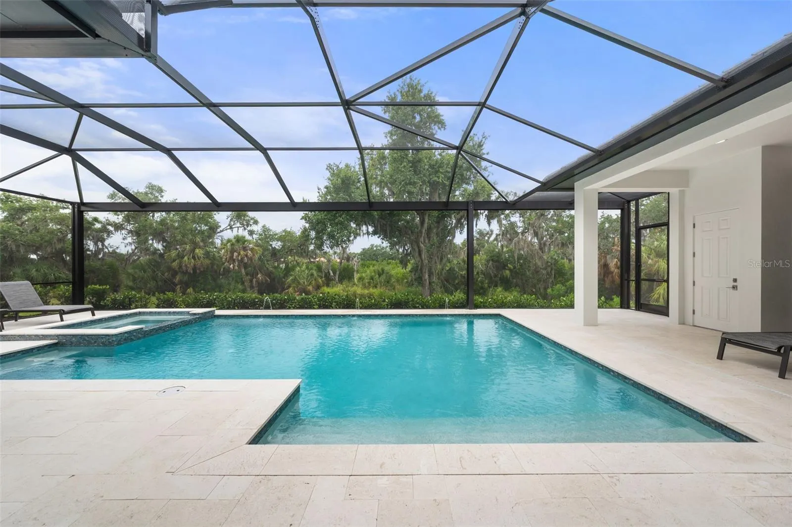 There is outdoor landscape and pool lighting that create the perfect evening atmosphere.