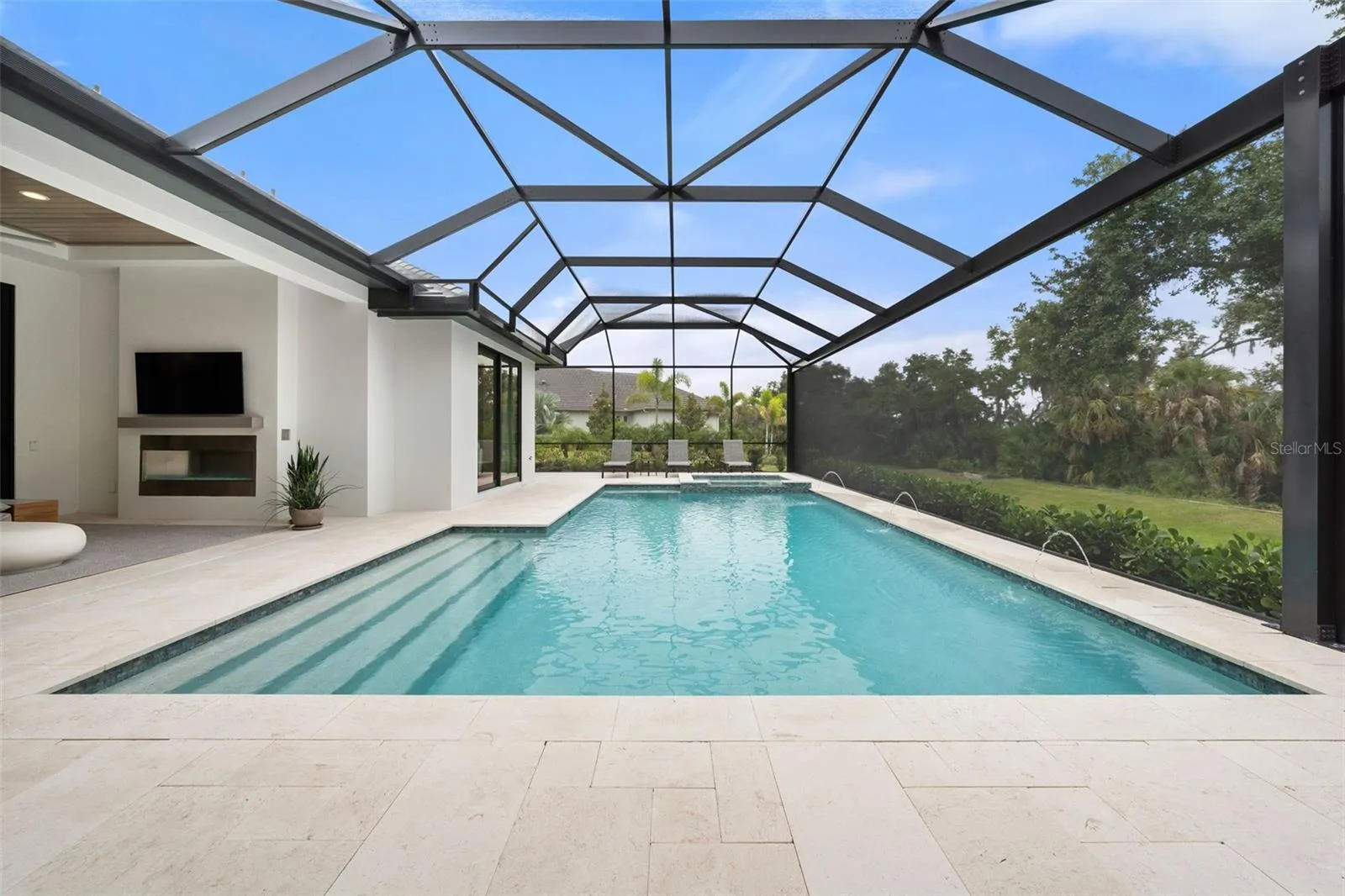 The resort-style saltwater pool and spa feature elegant water elements, an alarm system, and both solar and gas heating systems allowing for year-round enjoyment.