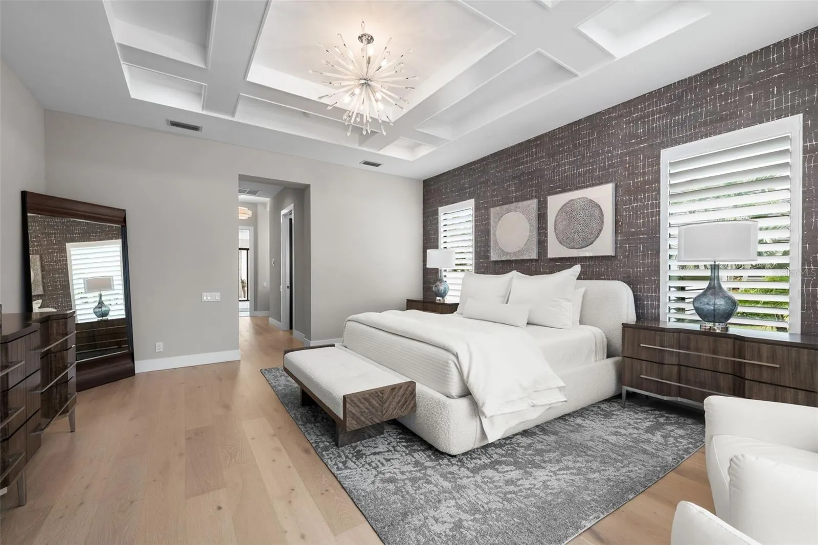 There are dual walk-in closets outfitted with extensive custom cabinetry and shelving provide exceptional organization and storage.