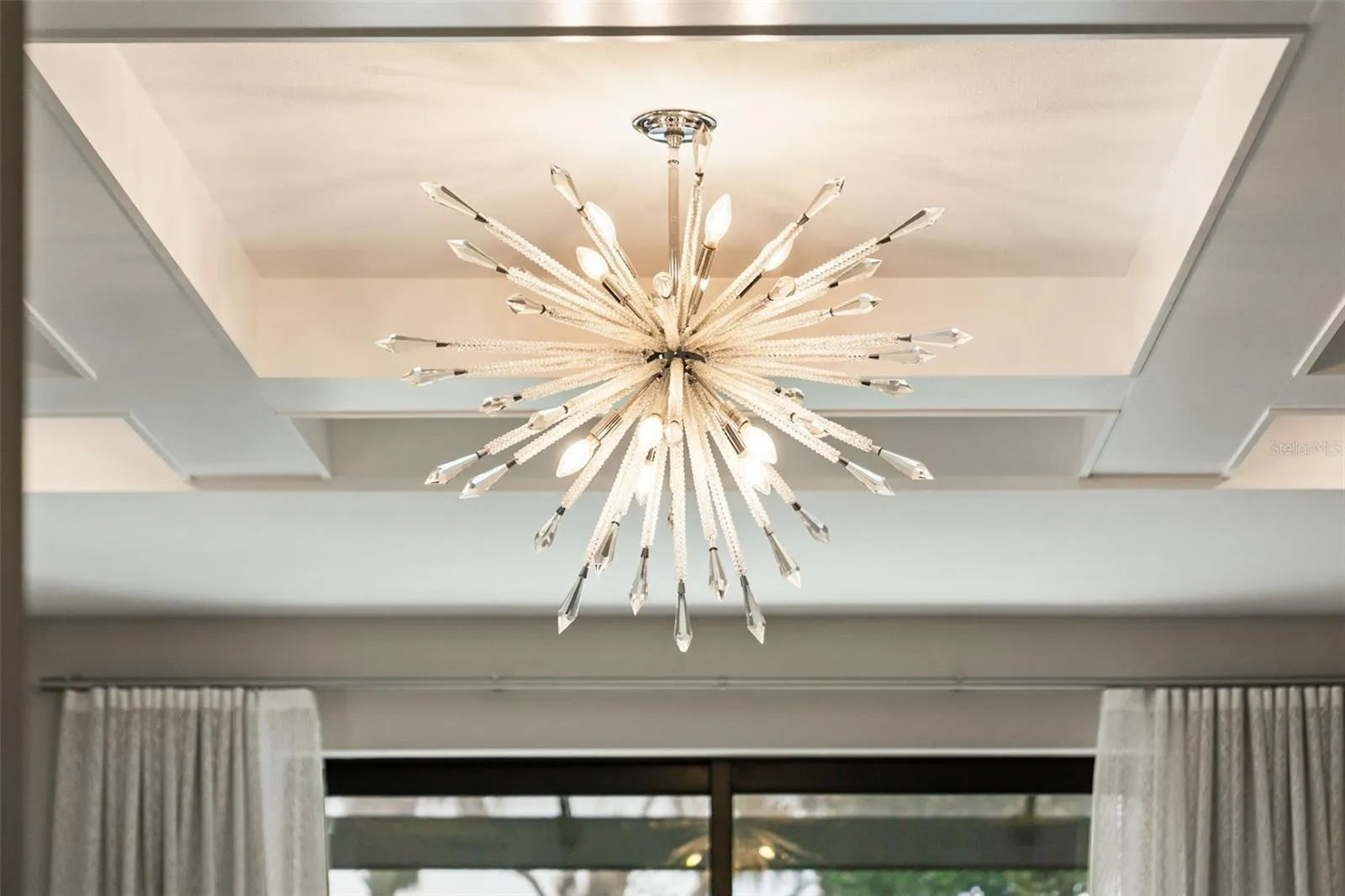 The Rousseau Articulating Chandelier accents the primary bedroom.