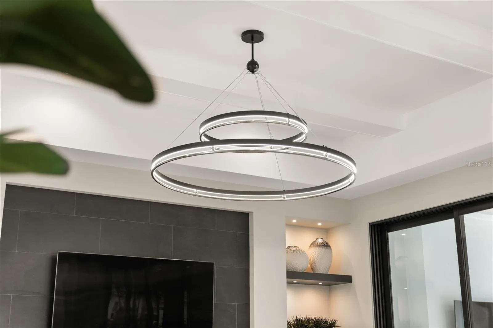 The great room has a beautiful Grande Illusion LED Ring Chandelier.