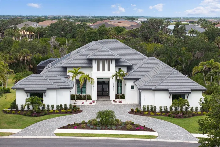 Tucked behind the gates of Parrish’s most exclusive waterfront community, this extraordinary custom residence is built by renowned luxury builder Arthur Rutenberg.