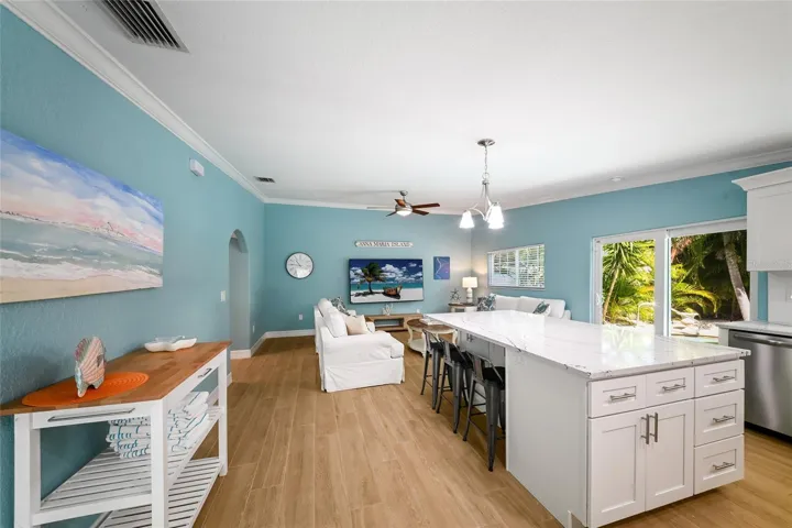 Great room w/ vaulted ceilings and crown molding