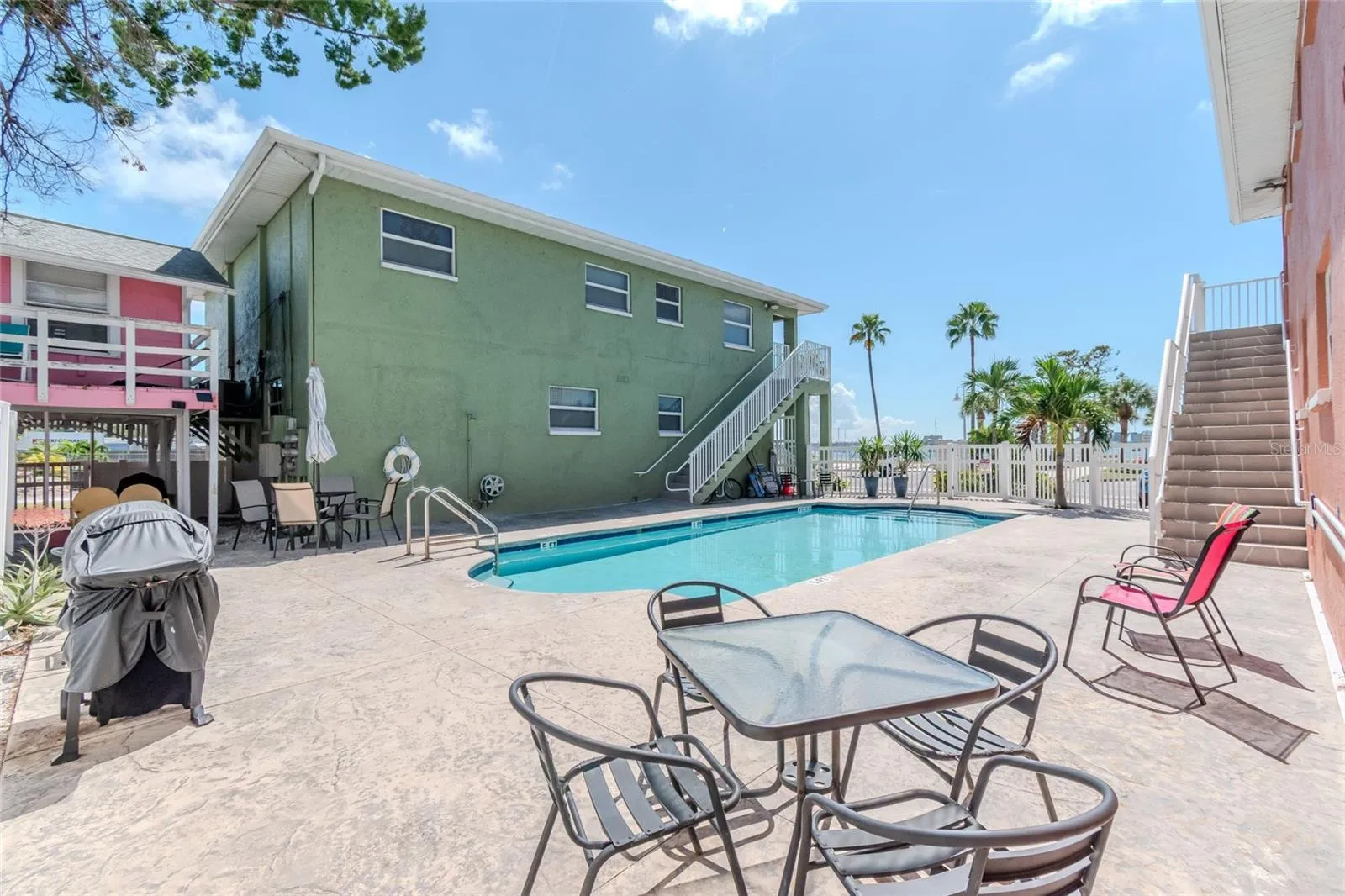 GREAT DECK AREA AROUND POOL, COMPLETE WITH GAS GRILL, TABLES AND CHAIRS