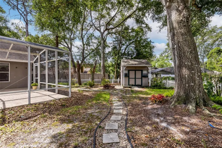 Backyard with mature plantings and a large shed