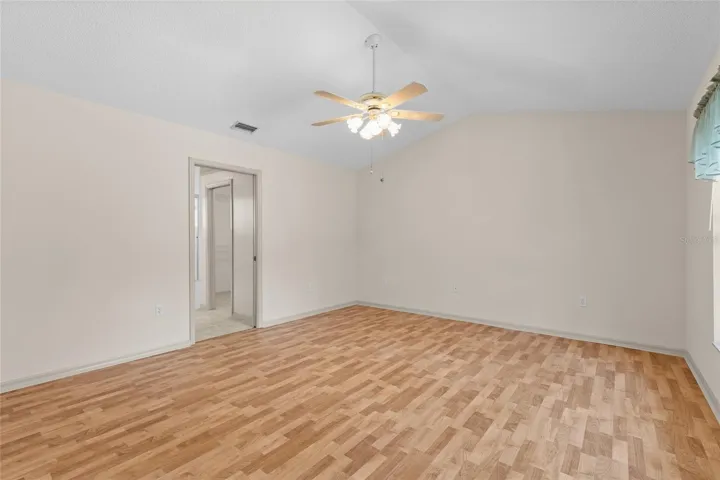 Primary bedroom with vaulted ceiling