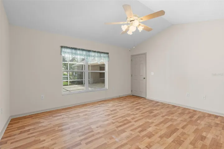 Primary bedroom with view to screened patio
