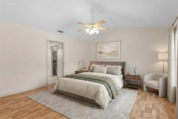 Primary bedroom with vaulted ceiling