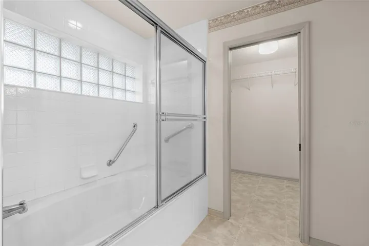 Ensuite bath with deep tub and view to walk in closet