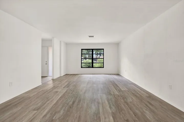 Alternative view of the massive living area highlighting the seamless flooring and flexible layout.